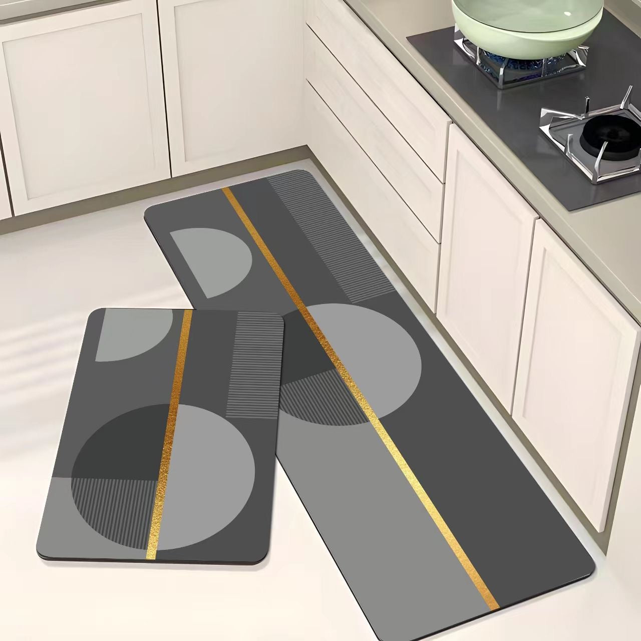 Set of two geometric-patterned kitchen mats on a floor with white cabinets and a stove in the background.