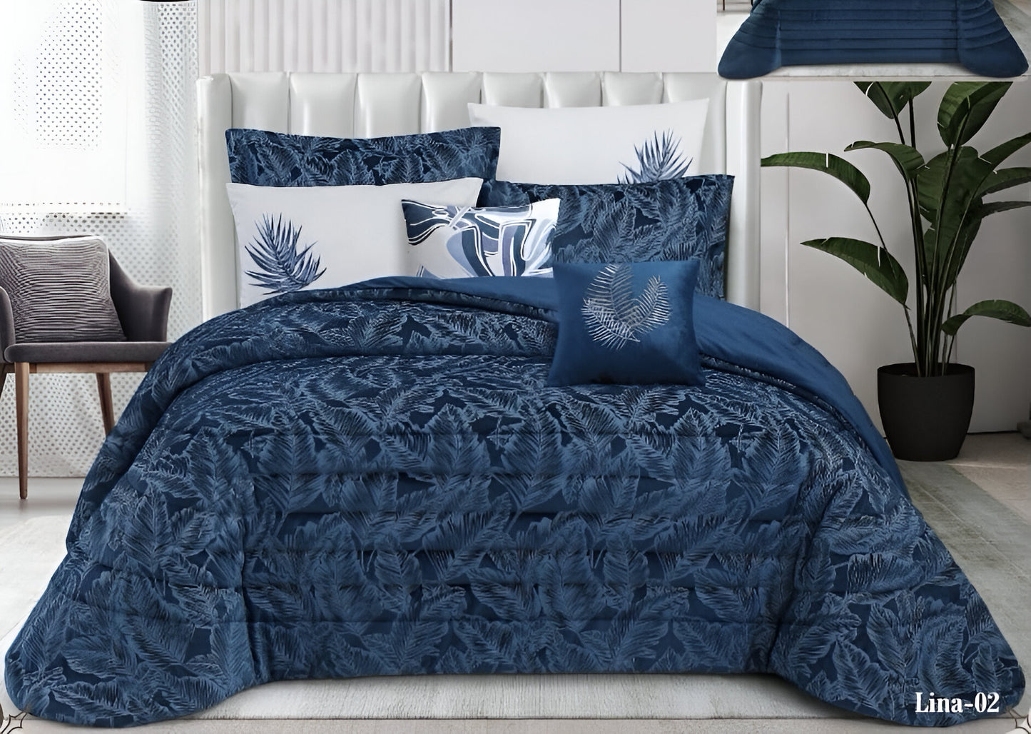 Blue patterned comforter set on a bed with matching pillows in a bedroom setting.