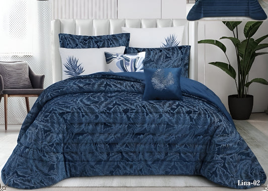 Blue patterned comforter set on a bed with matching pillows in a bedroom setting.