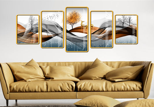 Five framed artworks on a wall above a beige sofa.